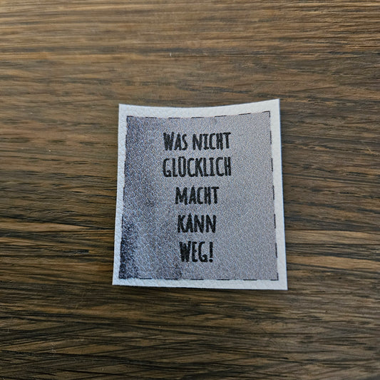Kunstlederlabel - Was nicht glücklich macht... Grau